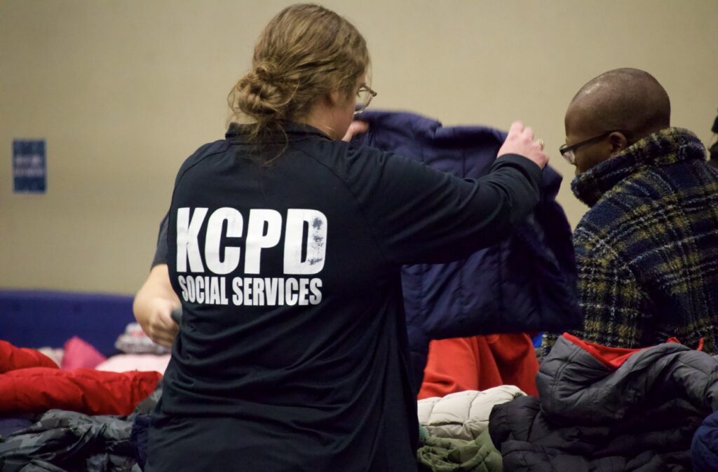 KCPD social services staff helping families choose winter coats
