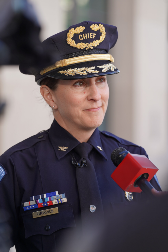 Smiling KCPD officer in a chief's dress uniform and cap